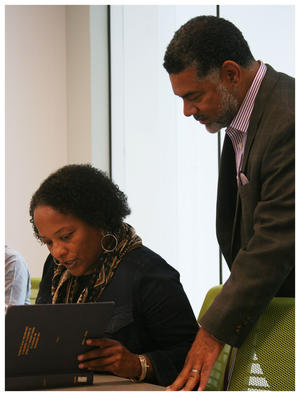 Alicia Dixon (sitting) and Board member Biff Clark look at Dr. Foster’s thesis. It’s the first time the institute viewed it.